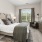 a bedroom with a bed and a chair