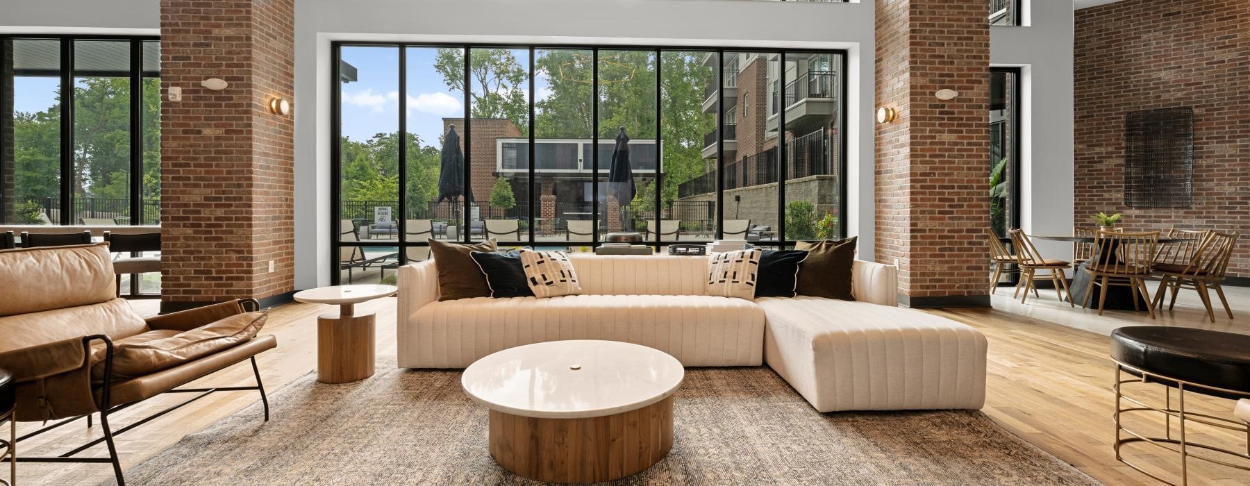 Resident lounge with  large windows overlooking courtyard at The Grace at Tryon Charlotte luxury apartments