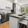 Kitchen with granite countertops and white cabinets at The Grace at Tryon upscale apartments in Charlotte