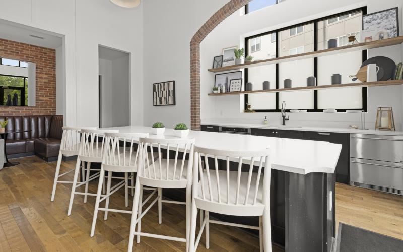 Chef's kitchen with island and bar stools at The Grace at Tryon luxury apartments in Charlotte, NC